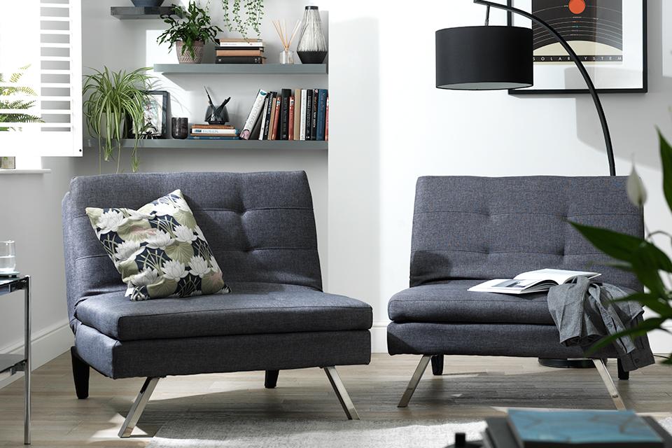 Two Dark Grey Futon Chair Beds with Silver color legs in library