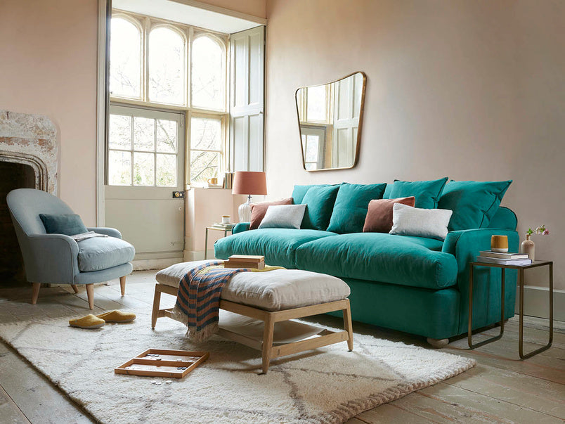 Beautiful Blue Color Sofa Chair Bed with Table and Cushions on it in the Living Room