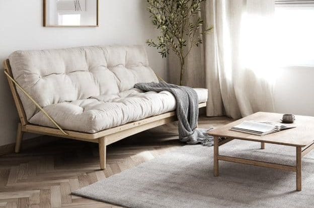 Cream Color Double Futon Chair Bed with blanket on it