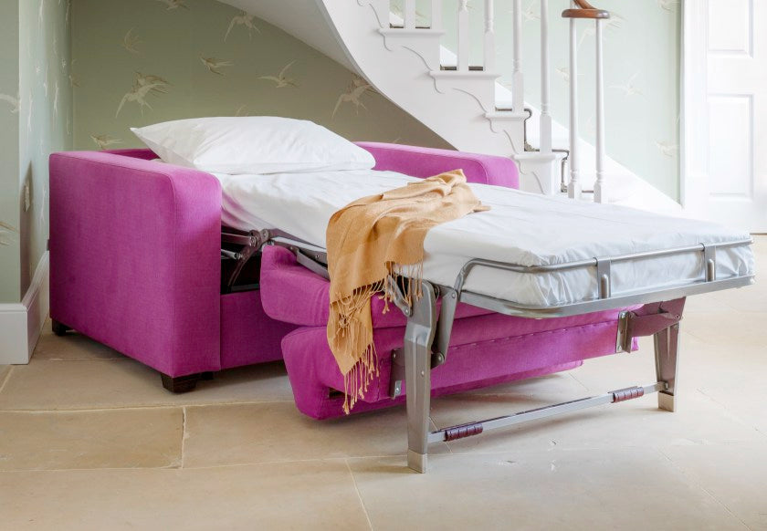Pink color chair as a bed in the living hall
