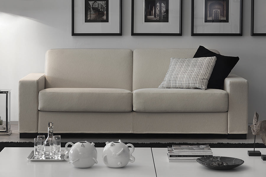 Cream Color Comfortable Chair Bed with two Cushions on it in living room