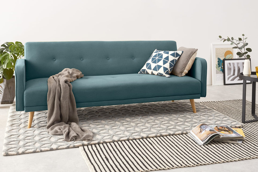 Double Sofa Bed in Blue Color with two Cushions on it