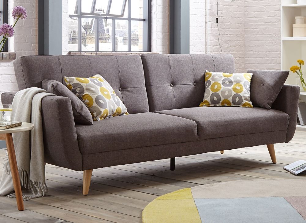 Light brown double sofa bed with cushions in the living room.