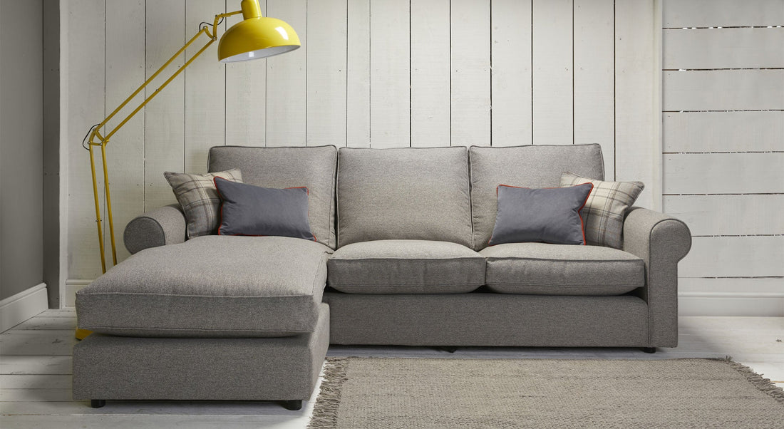 Grey Color Sofa Chair Bed with Cushions on it in the living room